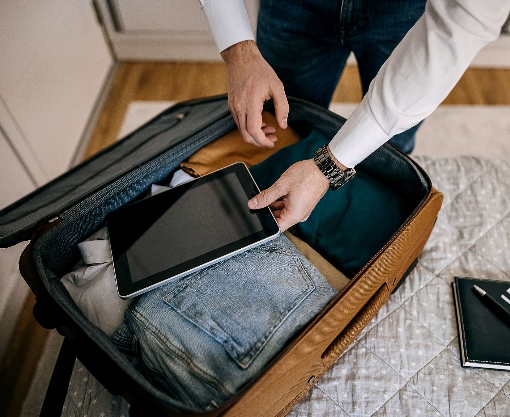 A business man packs a suitcase