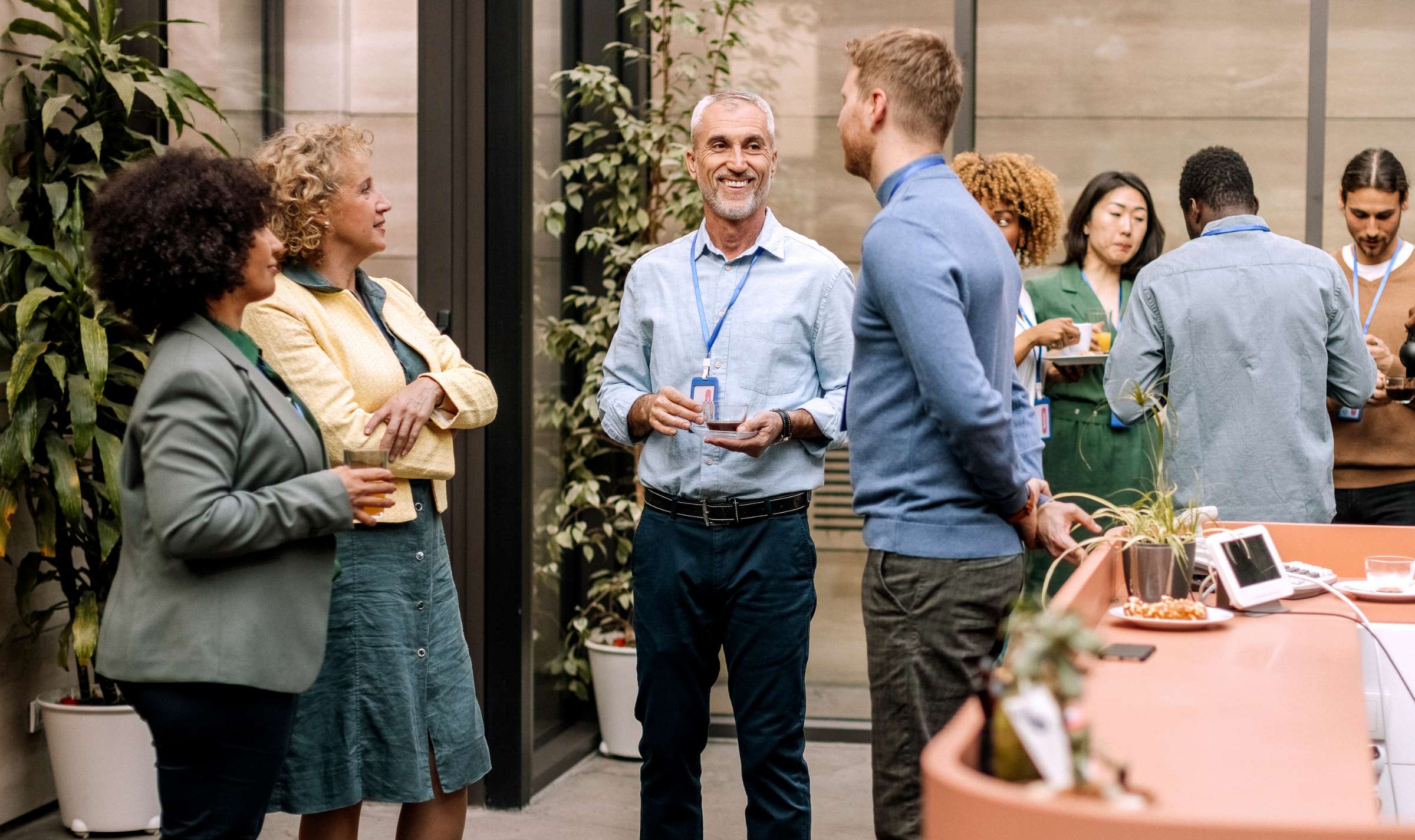 A group of people socialize in business attire