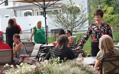A group of professionals mingle in an outdoor business patio