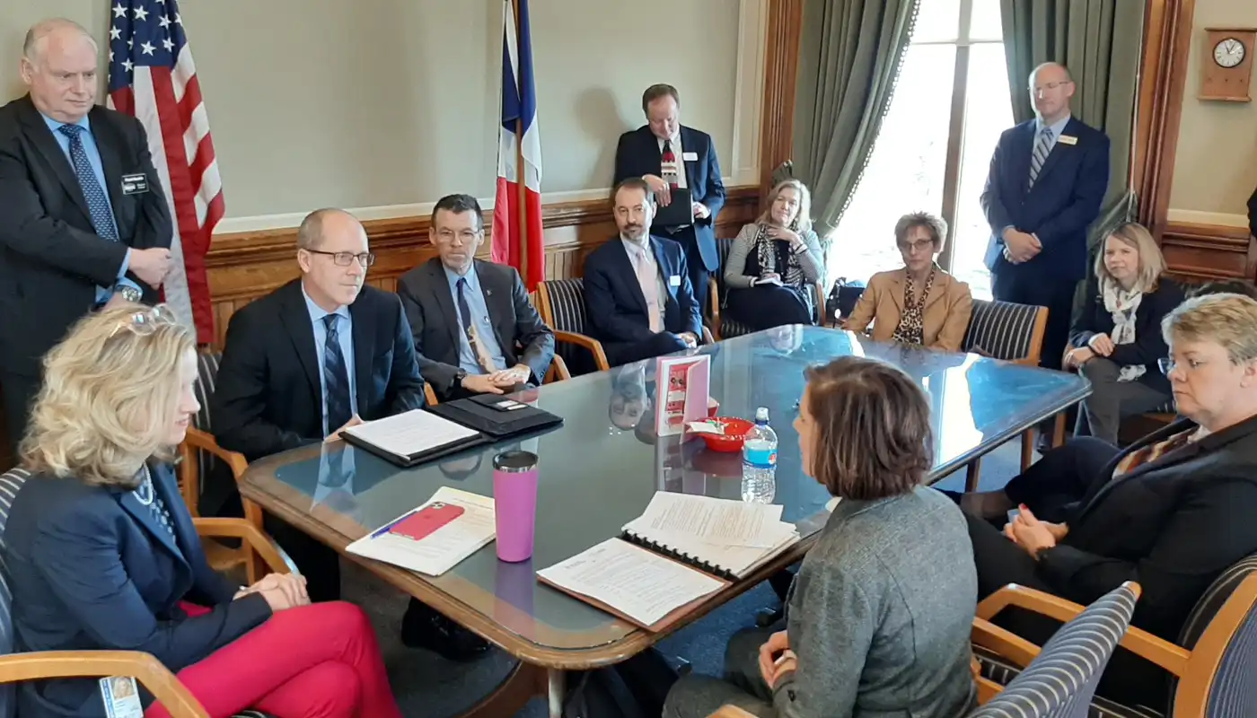 A group of people sit in an elected officials table