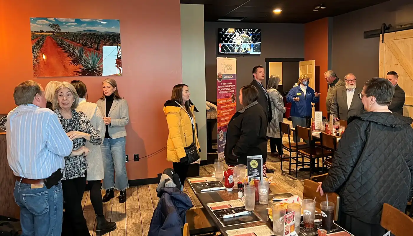 A group of lawmakers and citizens mingle at a bar