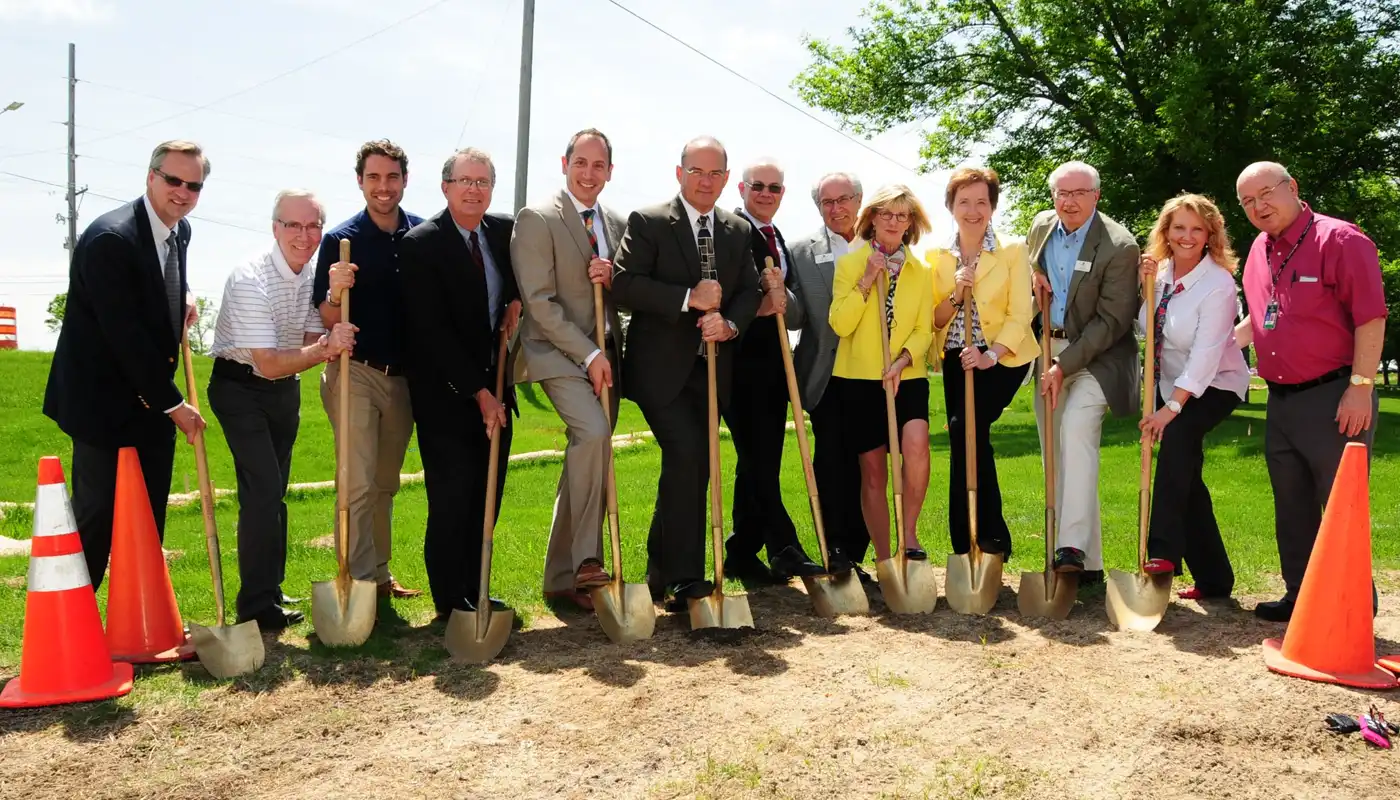A group of people pose with shovel at a grounbreaking event