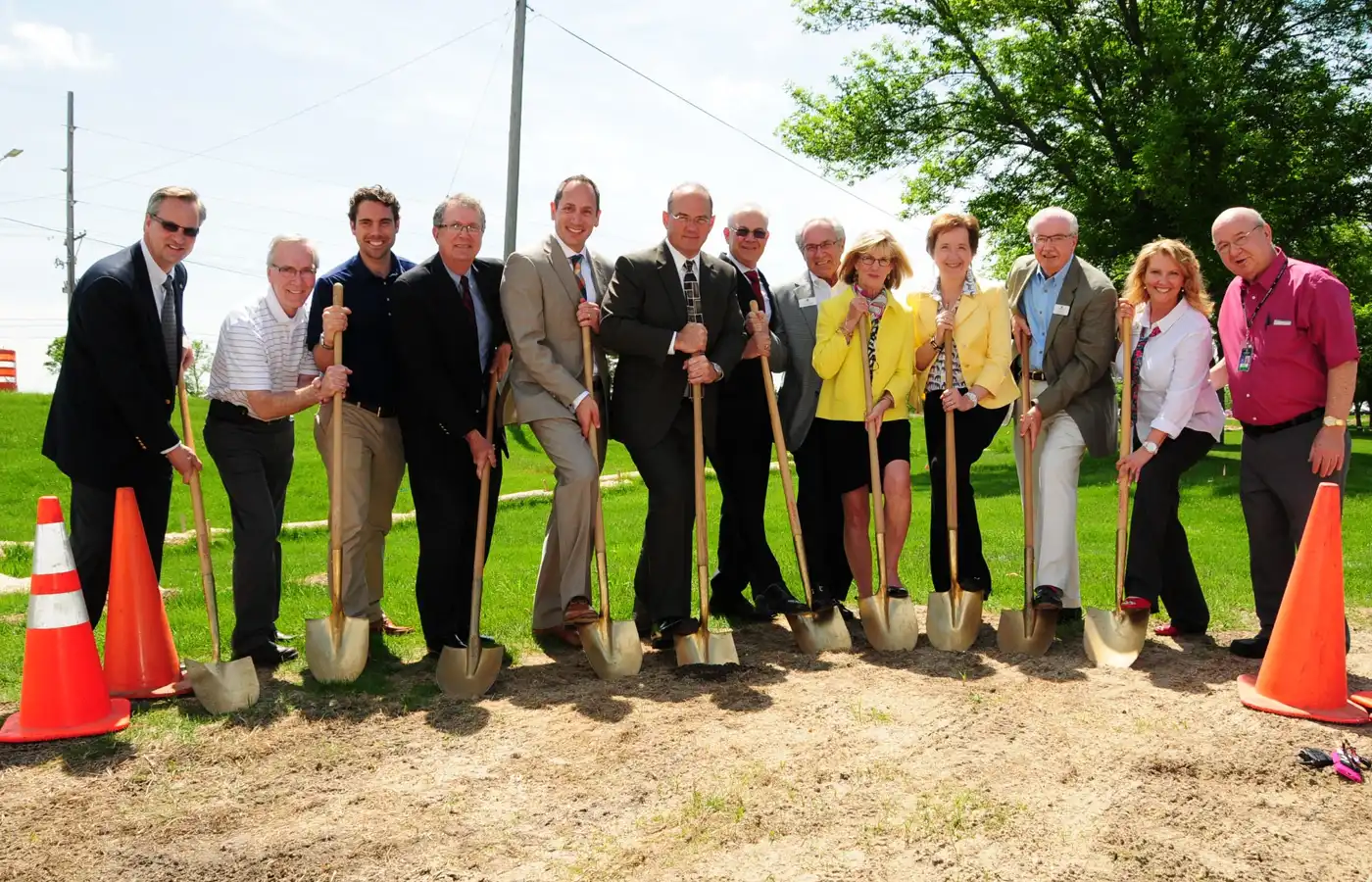 A group of people pose with shovel at a grounbreaking event