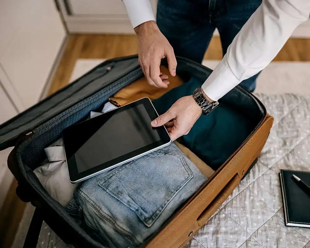 A business man packs a suitcase