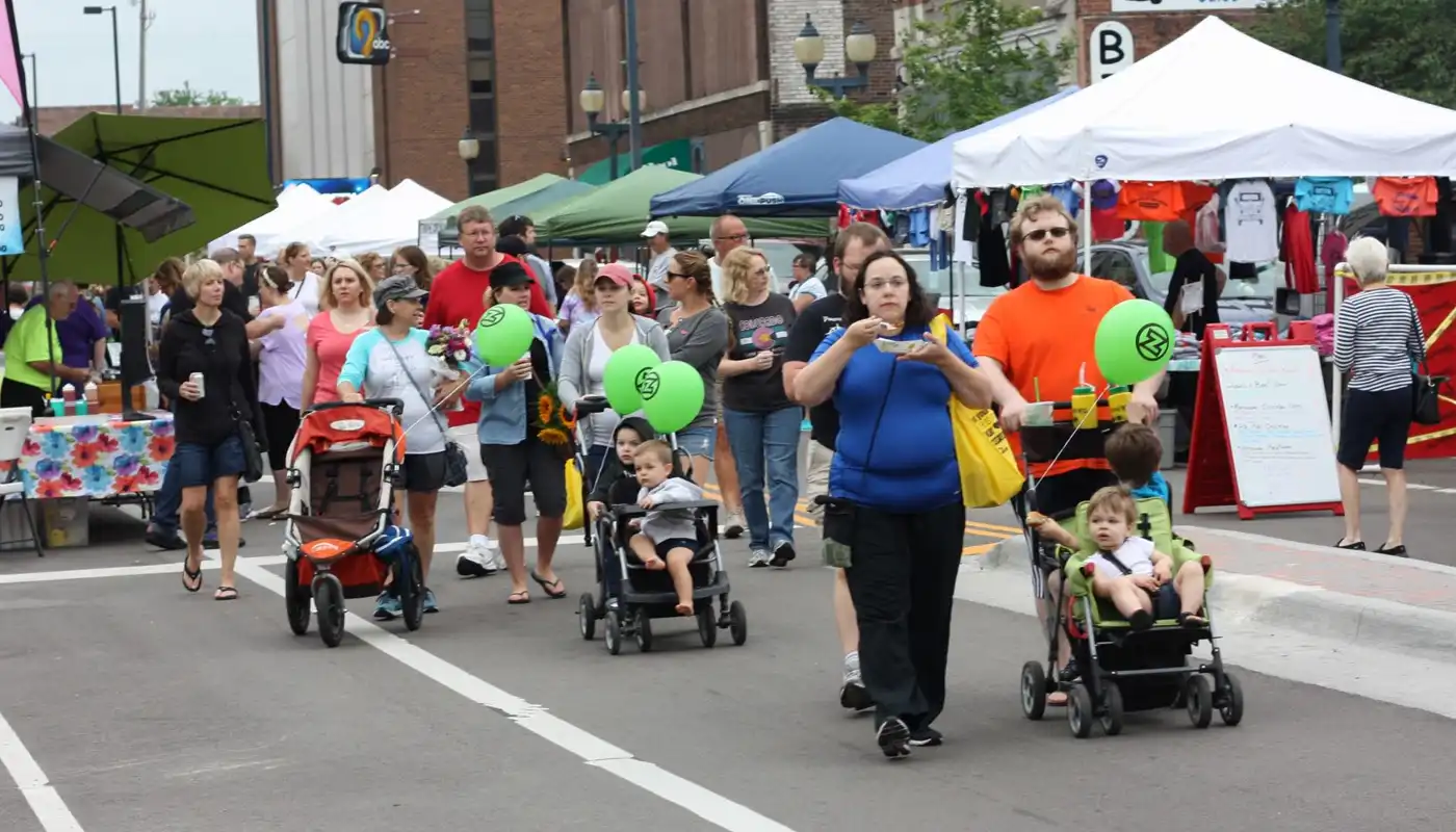 A group of patrons walk and enjoy the Cedar Rapids Downtown Farmers' Market