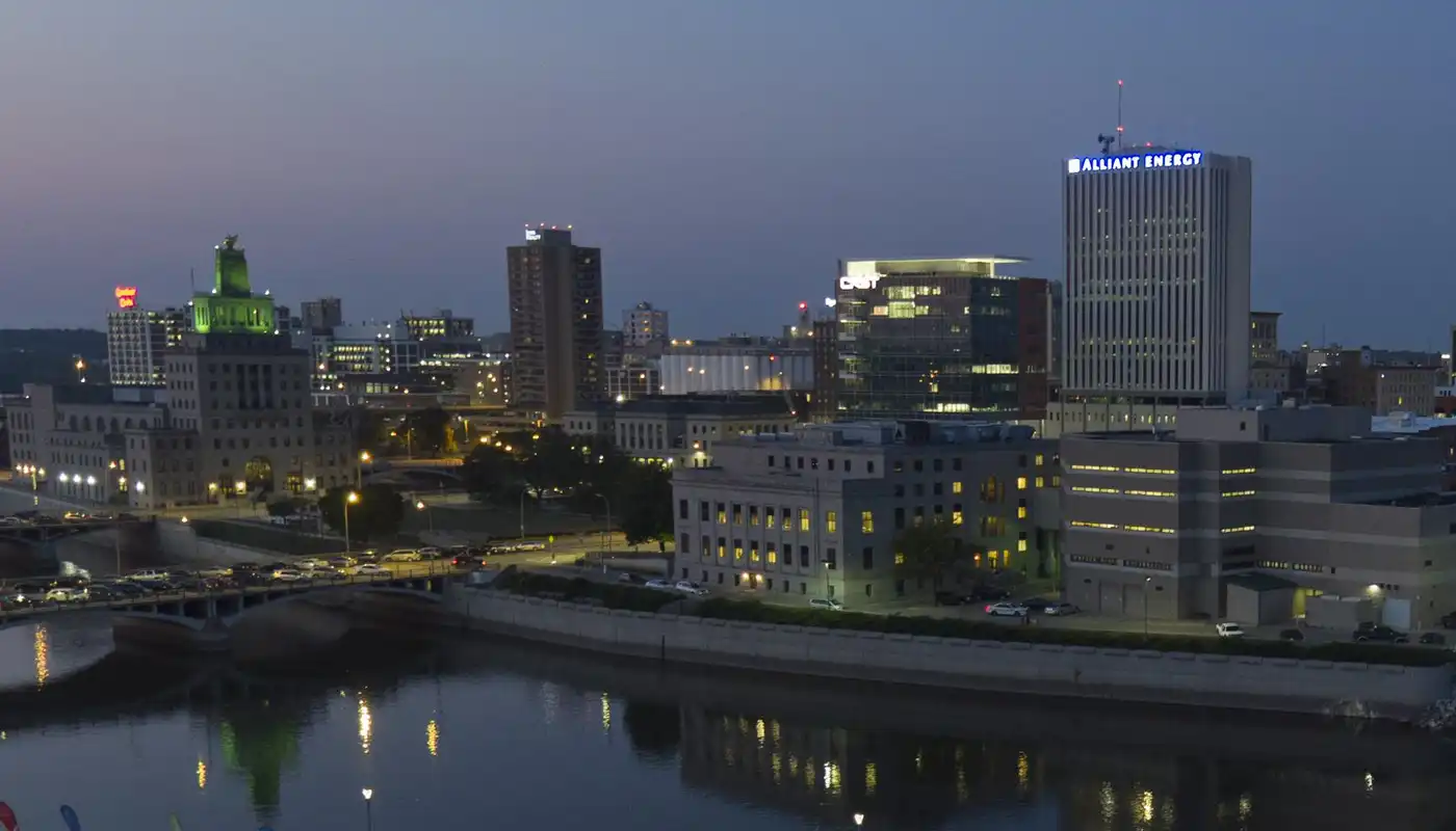 The Cedar Rapids skyline with tall buildings and lights at dusk