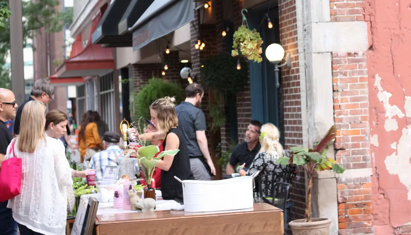 A vendor runs a booth at Market After Dark