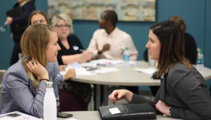 Two colleagues discuss items at a business get together