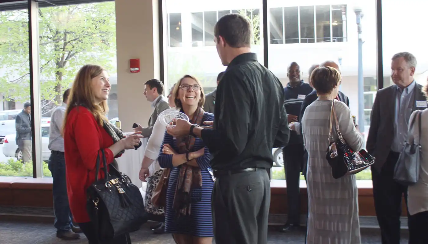 A group mingles in the lobby of the CRMEA building