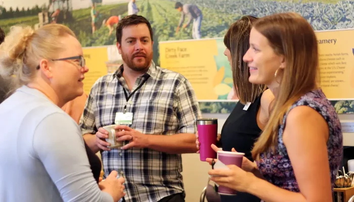 A group of people mingle at an event