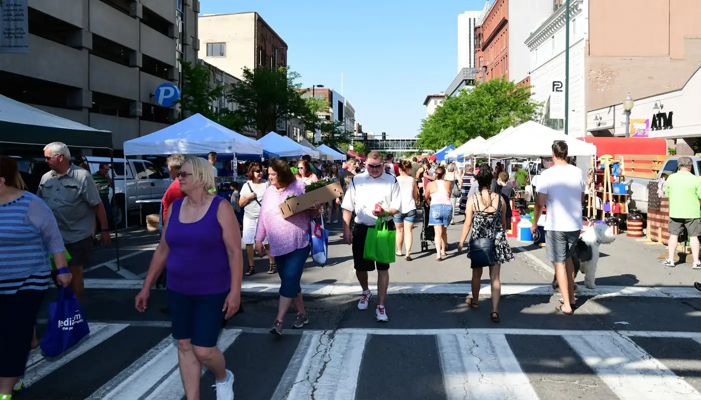 Patrons walk the streets of the Cedar Rapids downtown Farmers' Market