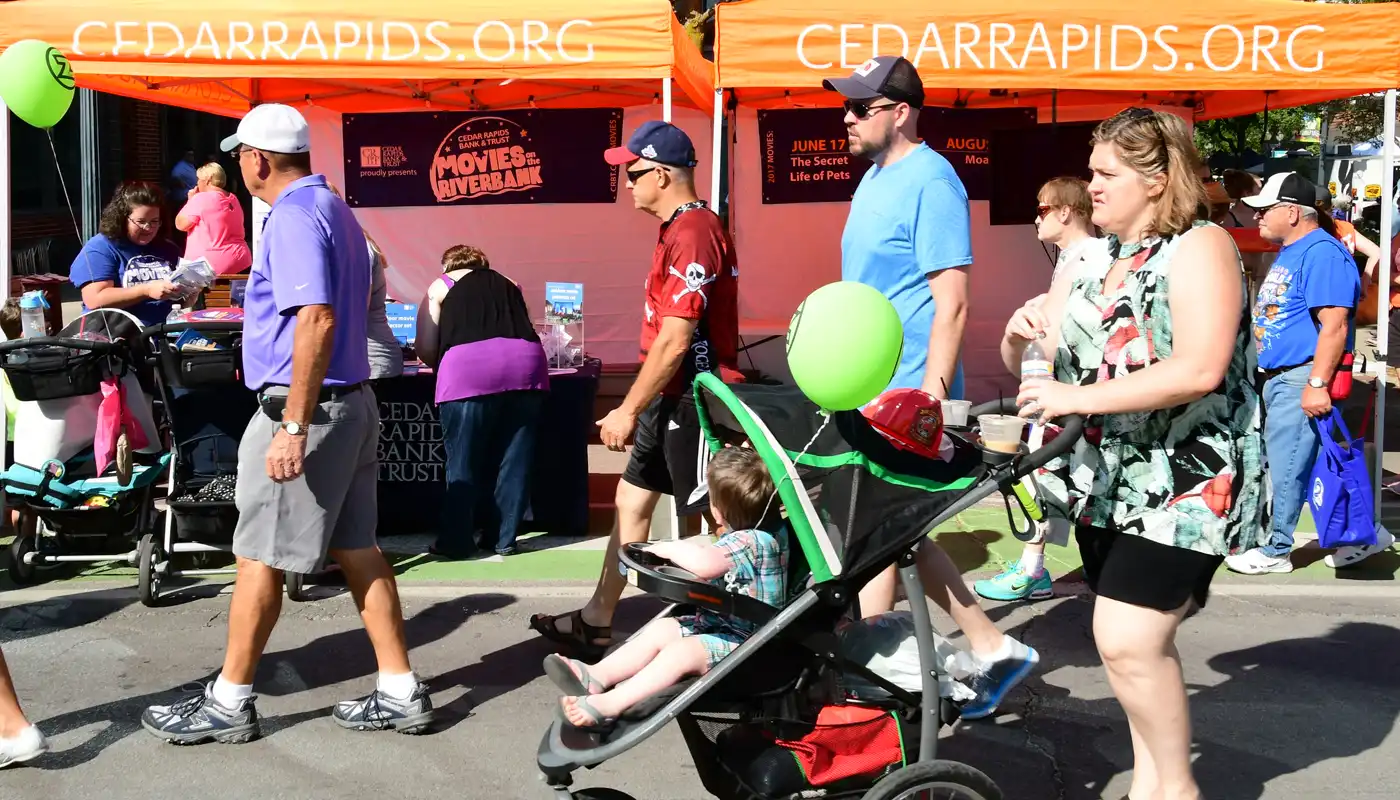 Patrons walk the streets of the Cedar Rapids Downtown Farmers' Market