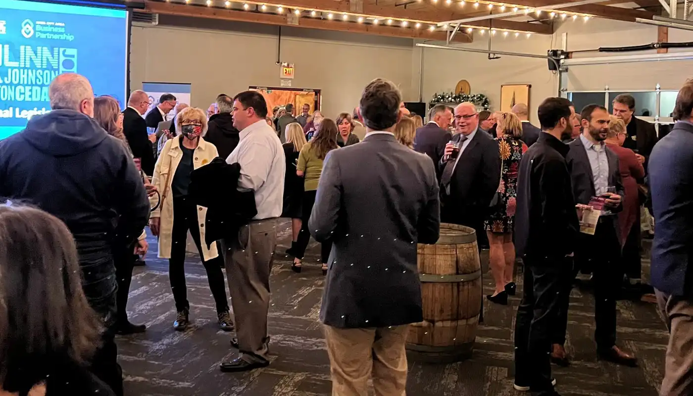 People gather and discuss in a large open ball room