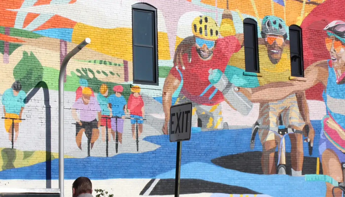 A mural on a building wall of cyclists