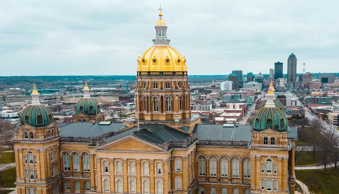 The Iowa state capitol with dome from an aerial shot with Des Moines skyline in the distance