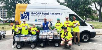 A group of people standing in front of HACAP Food Reservoir Van