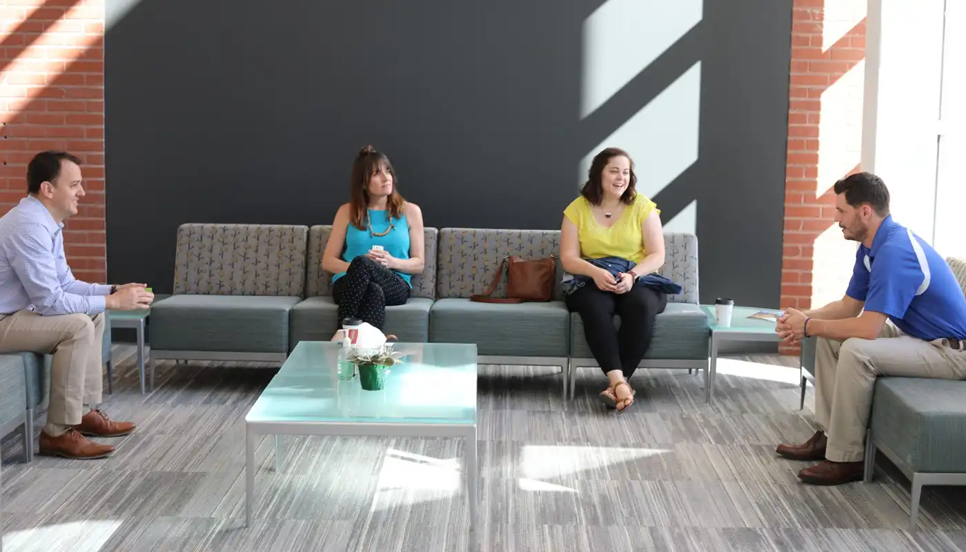 A group of young people sit in a lobby