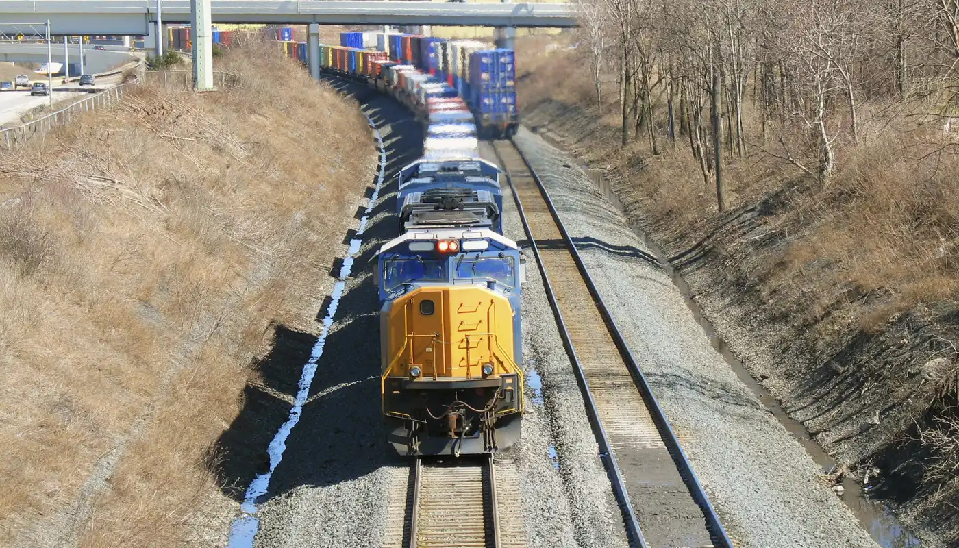 A train travels on train tracks in the Midwest