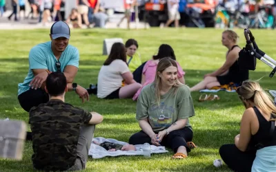 Young professionals hang out in a bright green park