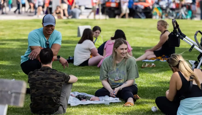 Young professionals hang out in a bright green park