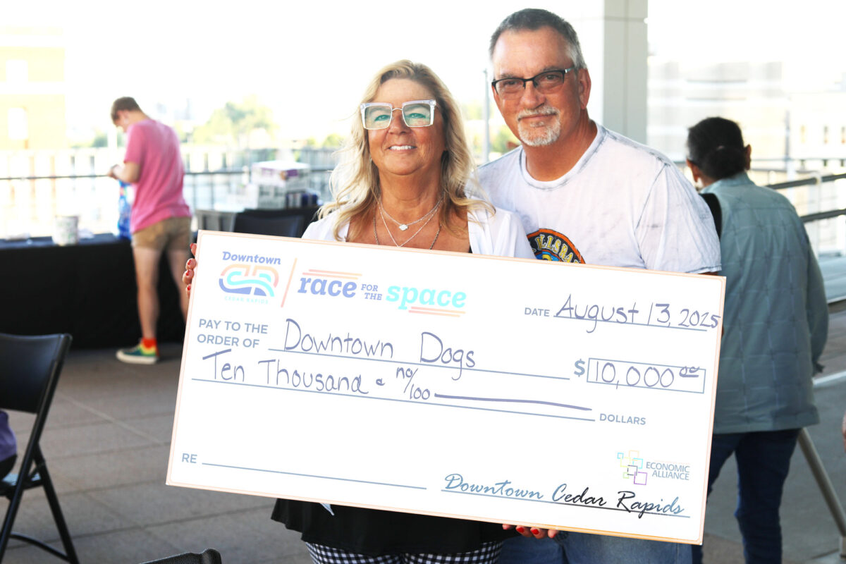 DawnLarie Michel with Downtown Dogs Canine Social Club accepts her second place check at Race for the Space Pitch Competition event in Cedar Rapids, Iowa on August 14, 2025